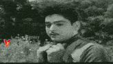 a black and white photo of a man with a mustache and a beard .