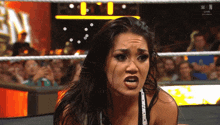 a woman in a wrestling ring with the letters w and n on the bottom
