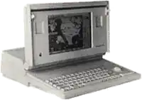 a black and white photo of an old laptop with a picture on the screen