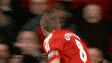 a man in a red jersey with the number 8 on it