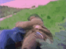 a blurry picture of a person laying on a grassy hillside