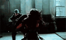 a man in a helmet is standing next to a woman in a dark room
