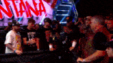 a man wearing a kenny 12 shirt stands in front of a crowd