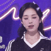 a close up of a girl wearing an adidas shirt