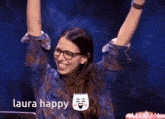 a woman wearing glasses is celebrating with her arms in the air with the words laura happy behind her