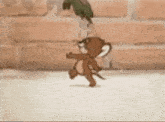 a cartoon character is running in front of a brick wall while a bird watches .