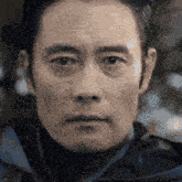 a close up of a man 's face in a blurry photo .