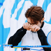 a man covering his face with his hands with zygm written on the bottom