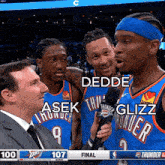 three thunder players are being interviewed by a man