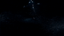 a silhouette of a person in a dark room with a light behind them
