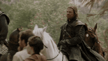 a man riding a horse with a sword in his right hand