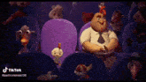 a group of cartoon characters are sitting in a theater and one of them is a rooster