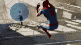 a man in a spiderman costume is jumping in the air in front of a satellite dish