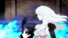 a woman with long white hair is standing in front of a blue fire .