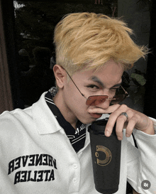 a man wearing sunglasses and a white shirt that says " a3v3eaeb " on it