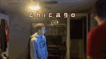 two men standing in a room with the word chicago written on the ceiling