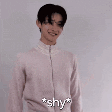 a man in a white shirt is smiling and says * shy * on the bottom