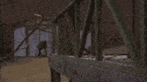 a man with his eyes taped is tied up in front of a shed