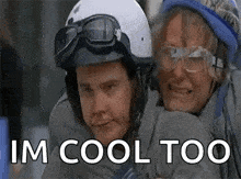 a man and a woman wearing helmets and goggles are hugging .