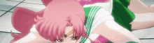 a pink haired anime girl is laying on the floor .