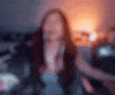 a blurry photo of a woman dancing in a dark room