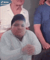 a tiktok video of a boy with a white shirt