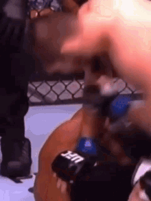 two men are fighting in a boxing ring .