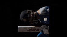 a cricket player is wearing a helmet and holding a bat that says mrf