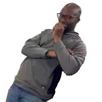 a man wearing glasses covering his face with his hands