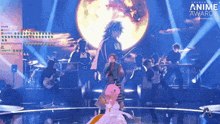 a group of people on a stage with the word anime on the bottom
