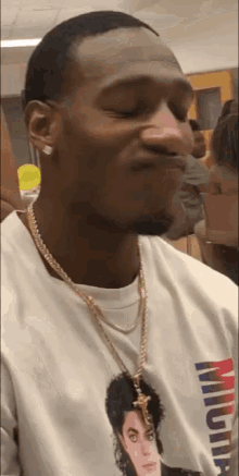 a man wearing a michael jackson t-shirt and a gold chain