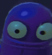 a close up of a purple cartoon character with big eyes and a blue background .