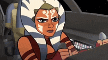 ahsoka tano from star wars is sitting in the cockpit of a spaceship .