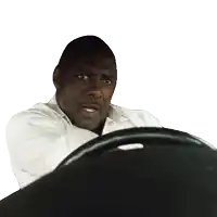 a man in a white shirt is holding the steering wheel of a car