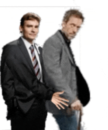 a man in a suit and tie stands next to another man