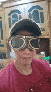 a man wearing a hat and goggles is smiling
