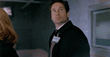 a man wearing a name tag that says notice on it