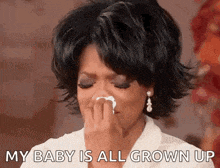 a woman is crying while holding a tissue in her hand and says my baby is all grown up