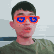 a man wearing sunglasses with the letter g on the lenses