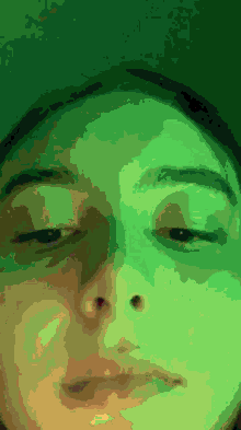 a close up of a person 's face with their eyes closed and a green background