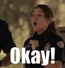 a woman in a police uniform says okay !