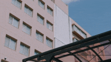 a building with lots of windows has a canopy over it