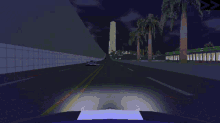a police car is driving down a road next to a car