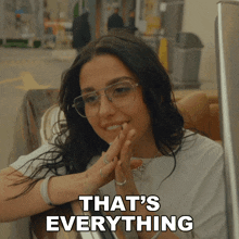 a woman with glasses says that 's everything in a car