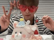 a person wearing red heart shaped glasses is holding up a peace sign