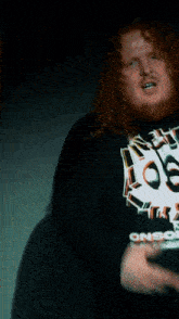 a man with a beard is wearing a shirt that says loser