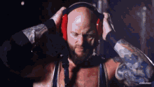 a man with a beard is wearing headphones on his head .