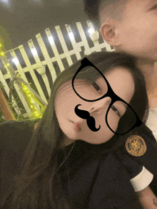 a woman wearing glasses and a fake mustache is laying on a man 's shoulder