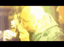a man in a green jacket is smoking a pipe
