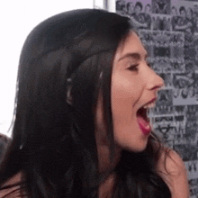a close up of a woman 's face with her mouth open and a collage of pictures in the background .